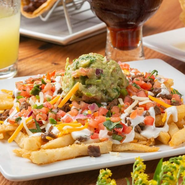 Mezcal Mexican Bar & Kitchen's loaded fries with guacamole, pico de gallo, cheese, and sour cream.
